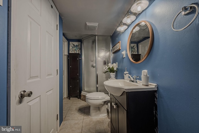 bathroom with tile patterned floors, vanity, walk in shower, and toilet