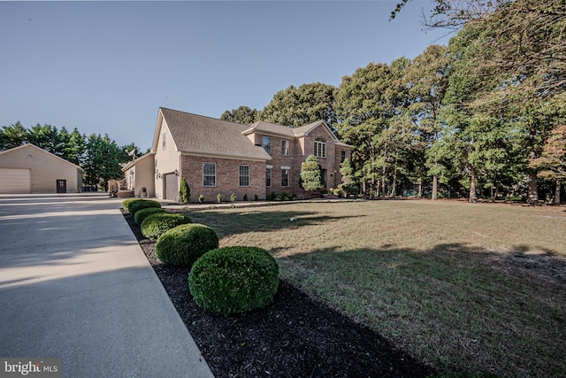 view of front facade with a garage and a front lawn