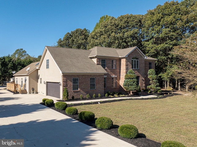 view of front of house with a garage and a front lawn