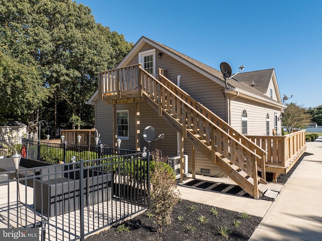 rear view of property featuring a patio area and a wooden deck