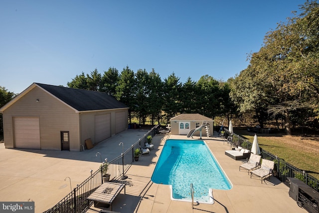 view of swimming pool featuring a patio and an outdoor structure