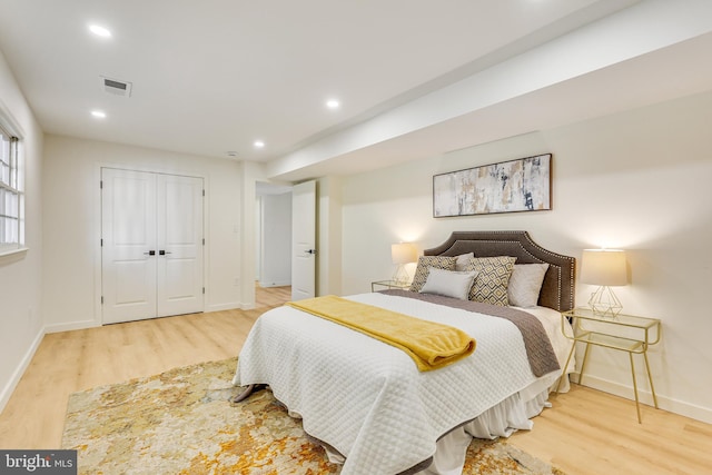 bedroom featuring light wood-type flooring and a closet