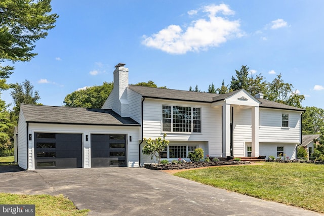 split foyer home with a front lawn and a garage