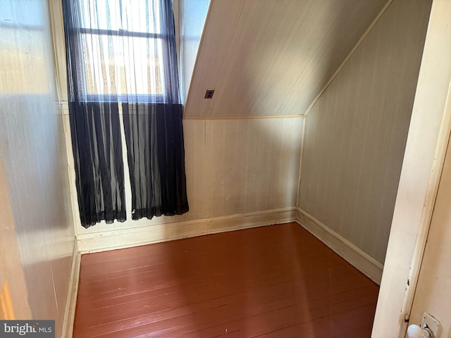 additional living space featuring hardwood / wood-style floors and vaulted ceiling