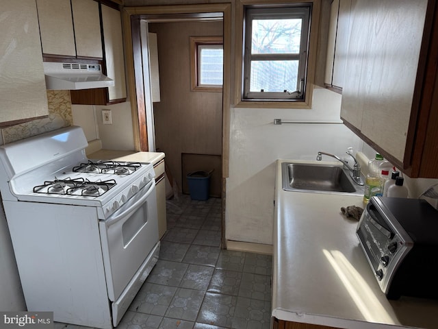 kitchen featuring white range with gas stovetop and sink