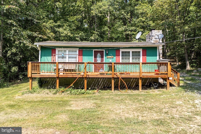 view of front of property with a front yard and a deck