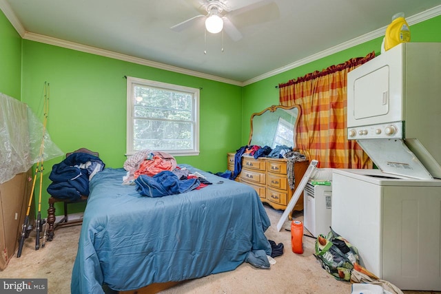 carpeted bedroom with ornamental molding, stacked washer and clothes dryer, and ceiling fan