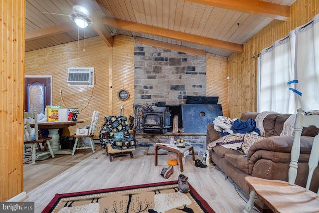 living room with wood-type flooring, wooden walls, and ceiling fan