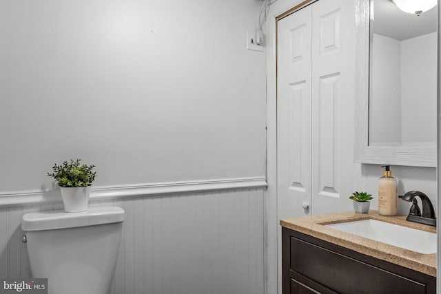 bathroom featuring toilet and vanity