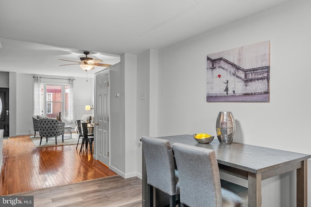 dining area featuring hardwood / wood-style floors and ceiling fan