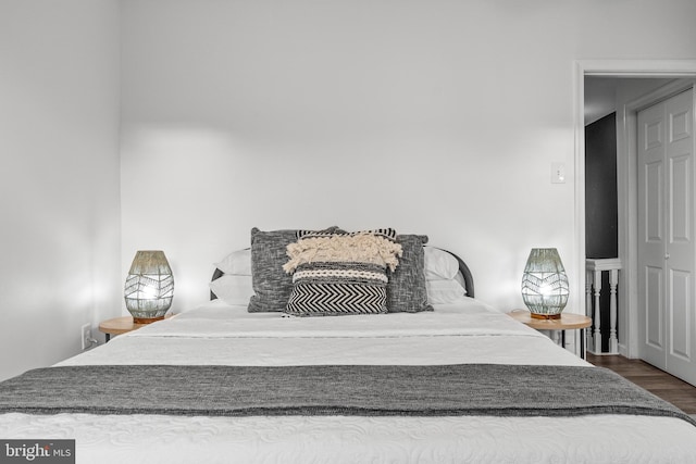 bedroom with dark wood-type flooring