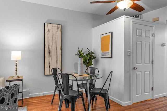 dining room with hardwood / wood-style floors and ceiling fan