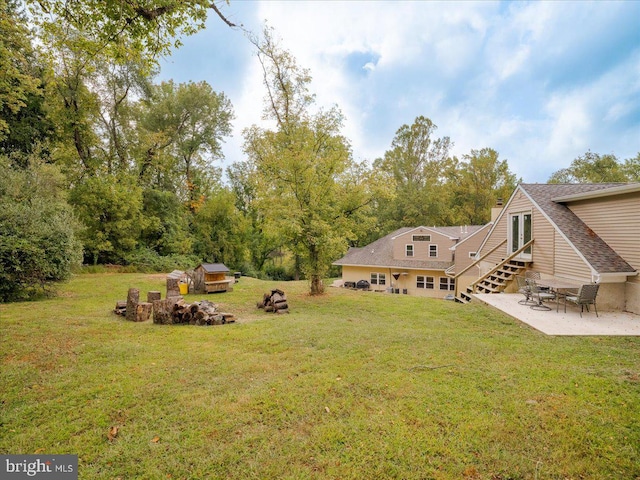 view of yard with a patio and a fire pit