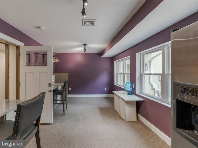 office space with rail lighting, baseboards, visible vents, and light colored carpet