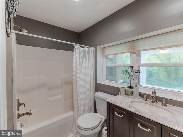 bathroom featuring toilet, shower / bath combo, and vanity