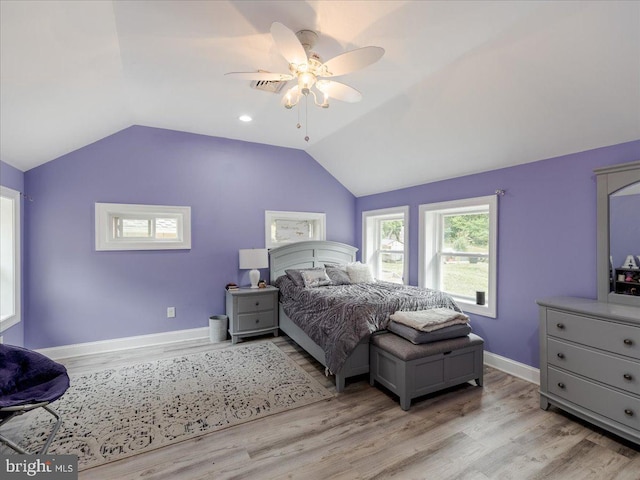 bedroom featuring ceiling fan, light wood-type flooring, and lofted ceiling