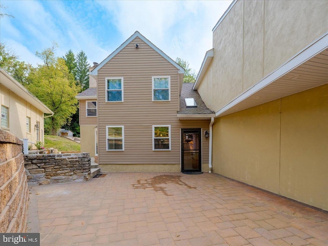 rear view of property featuring a patio area and stucco siding