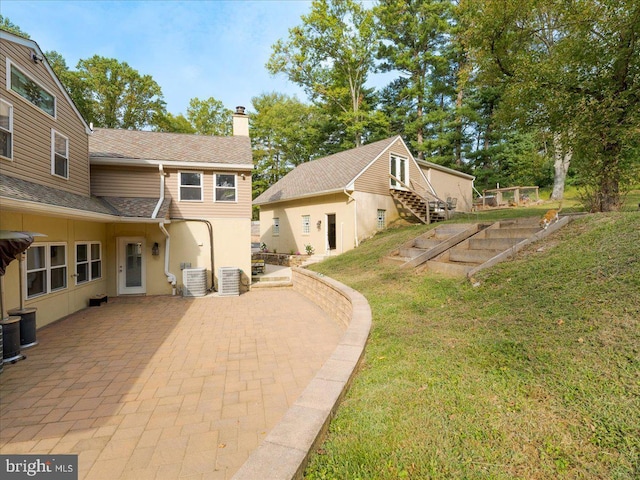 view of yard with a patio area and central air condition unit