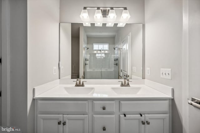 bathroom with vanity and a shower with door