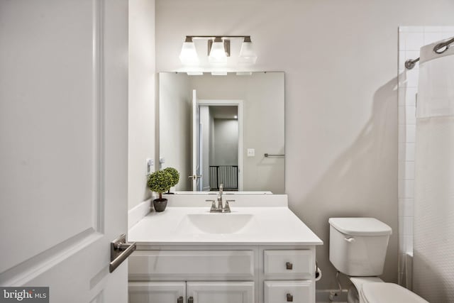 bathroom featuring vanity, toilet, and curtained shower