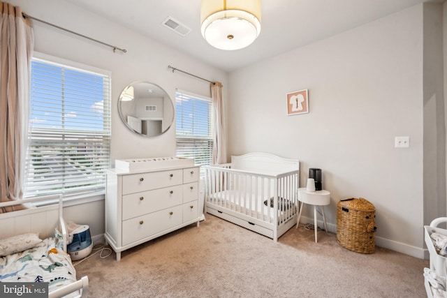 carpeted bedroom with a crib