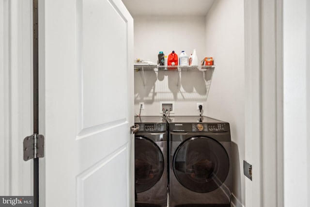 clothes washing area featuring washer and clothes dryer