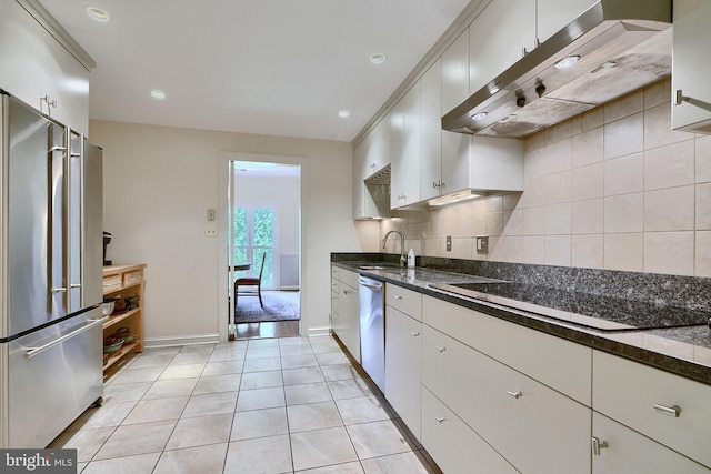 kitchen featuring light wood-type flooring, backsplash, stainless steel appliances, sink, and wall chimney range hood