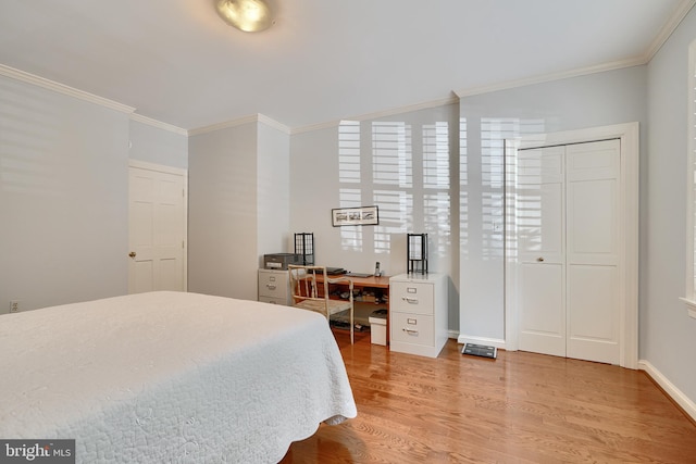 bedroom with light wood-style flooring, ornamental molding, and baseboards