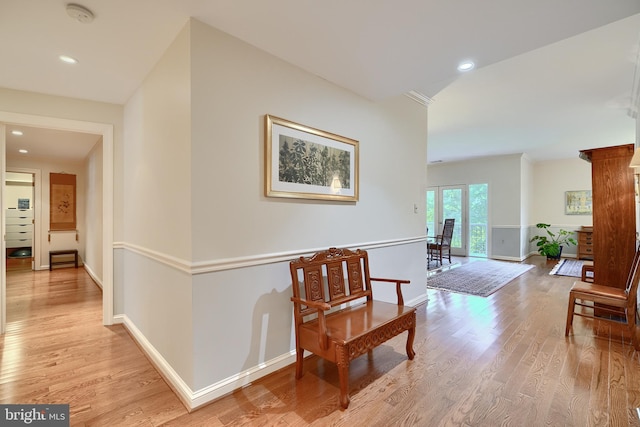 corridor featuring recessed lighting, baseboards, and light wood finished floors