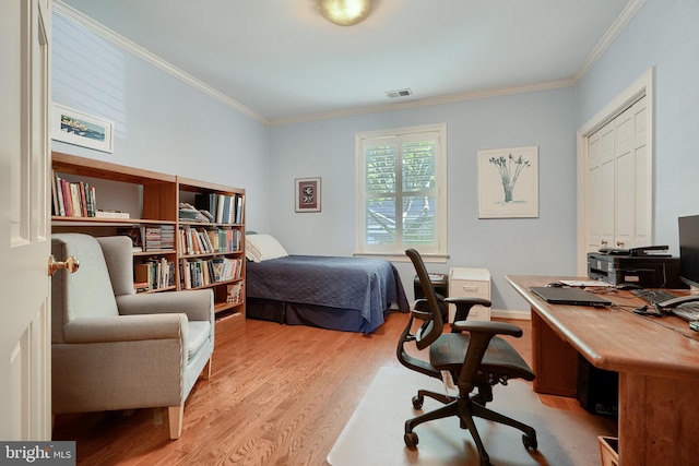 bedroom with ornamental molding, visible vents, and light wood finished floors