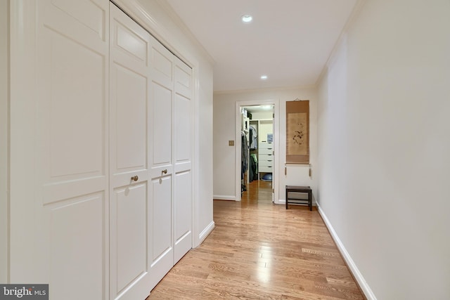 corridor with recessed lighting, crown molding, light wood-style flooring, and baseboards