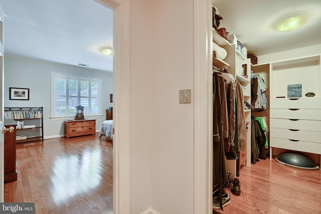 walk in closet featuring visible vents and wood finished floors