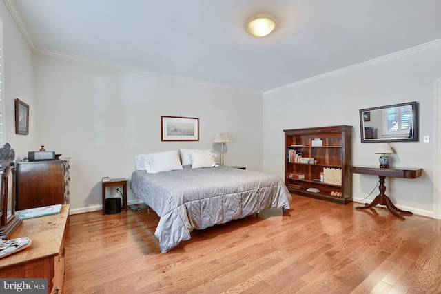 bedroom featuring ornamental molding and hardwood / wood-style flooring