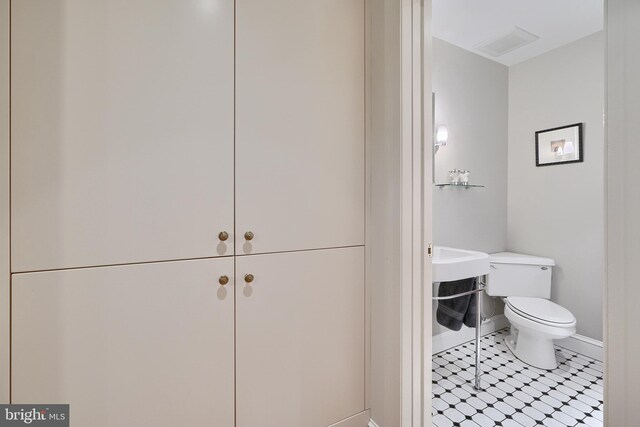 bathroom with toilet and tile patterned floors