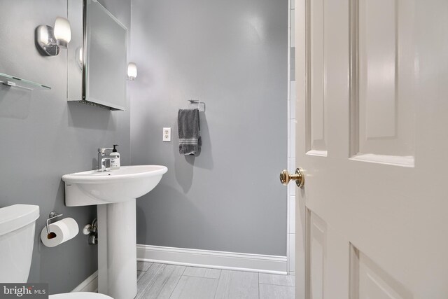 bathroom featuring tile patterned flooring and toilet