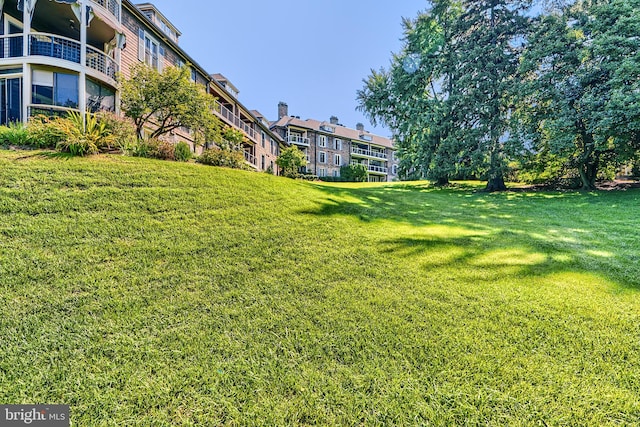 view of yard with a balcony