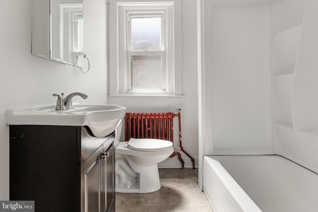 bathroom with vanity, toilet, and radiator