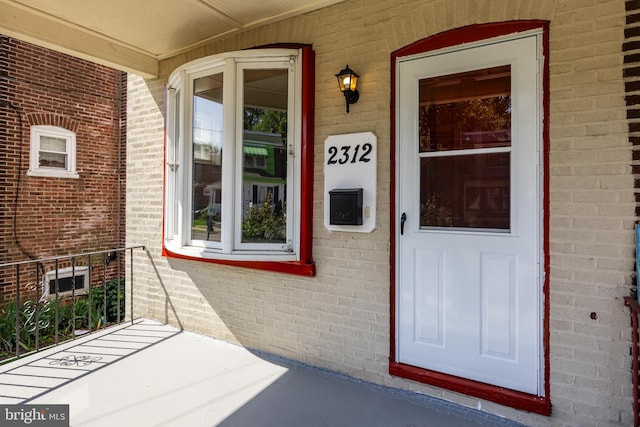 doorway to property featuring covered porch