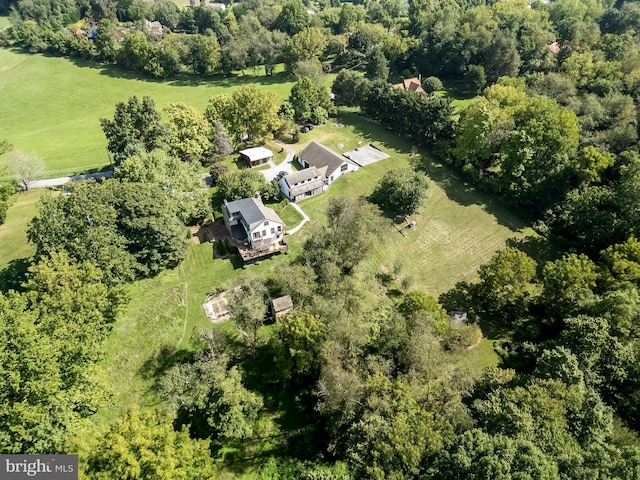 bird's eye view with a wooded view