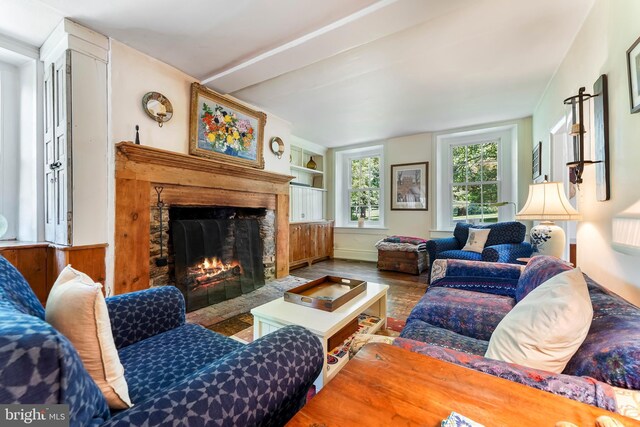 living room featuring wood-type flooring and built in features