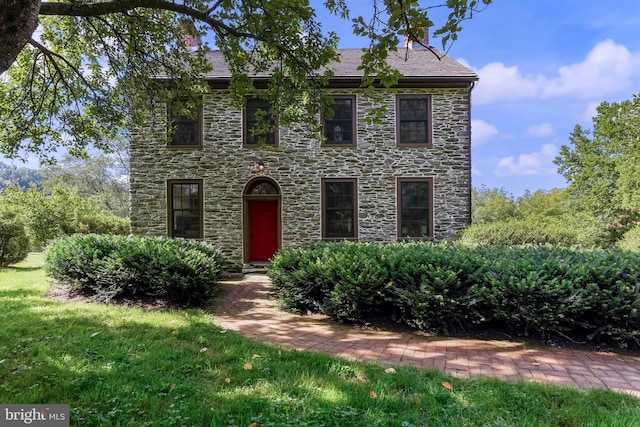 colonial-style house with a front yard