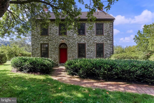 colonial-style house with stone siding