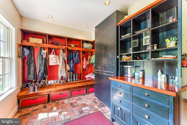 mudroom featuring brick floor and recessed lighting