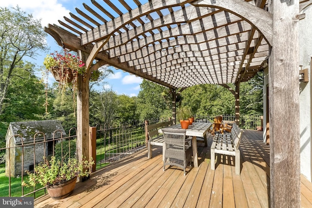 deck featuring a pergola and outdoor dining area