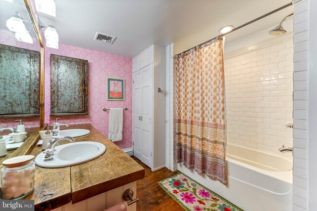 bathroom featuring shower / tub combo and vanity