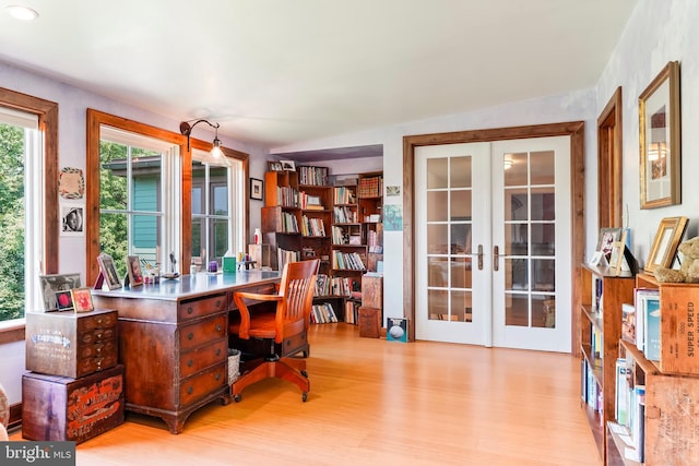 office featuring light hardwood / wood-style floors and french doors