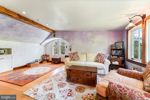 living room featuring light hardwood / wood-style flooring and lofted ceiling with beams