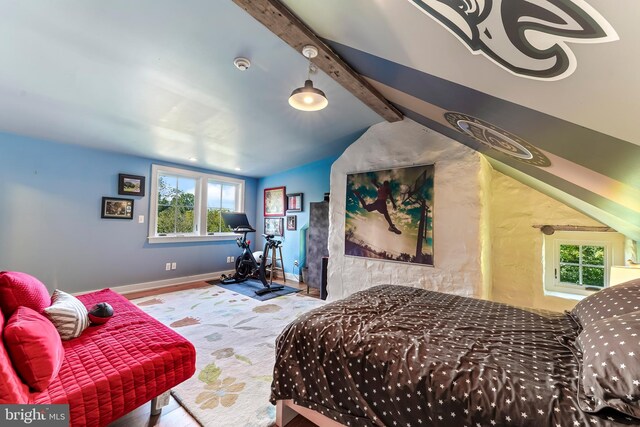 bedroom with lofted ceiling with beams