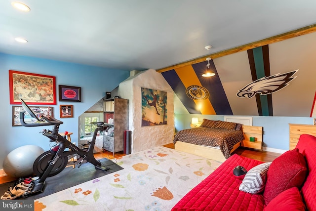 bedroom featuring lofted ceiling and wood finished floors