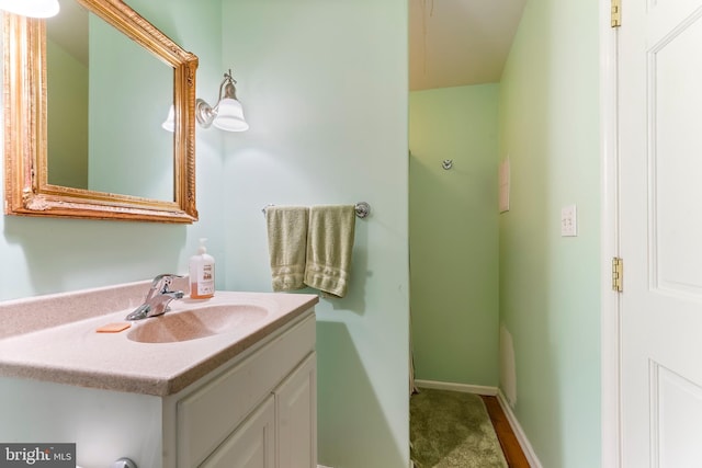 bathroom featuring baseboards and vanity